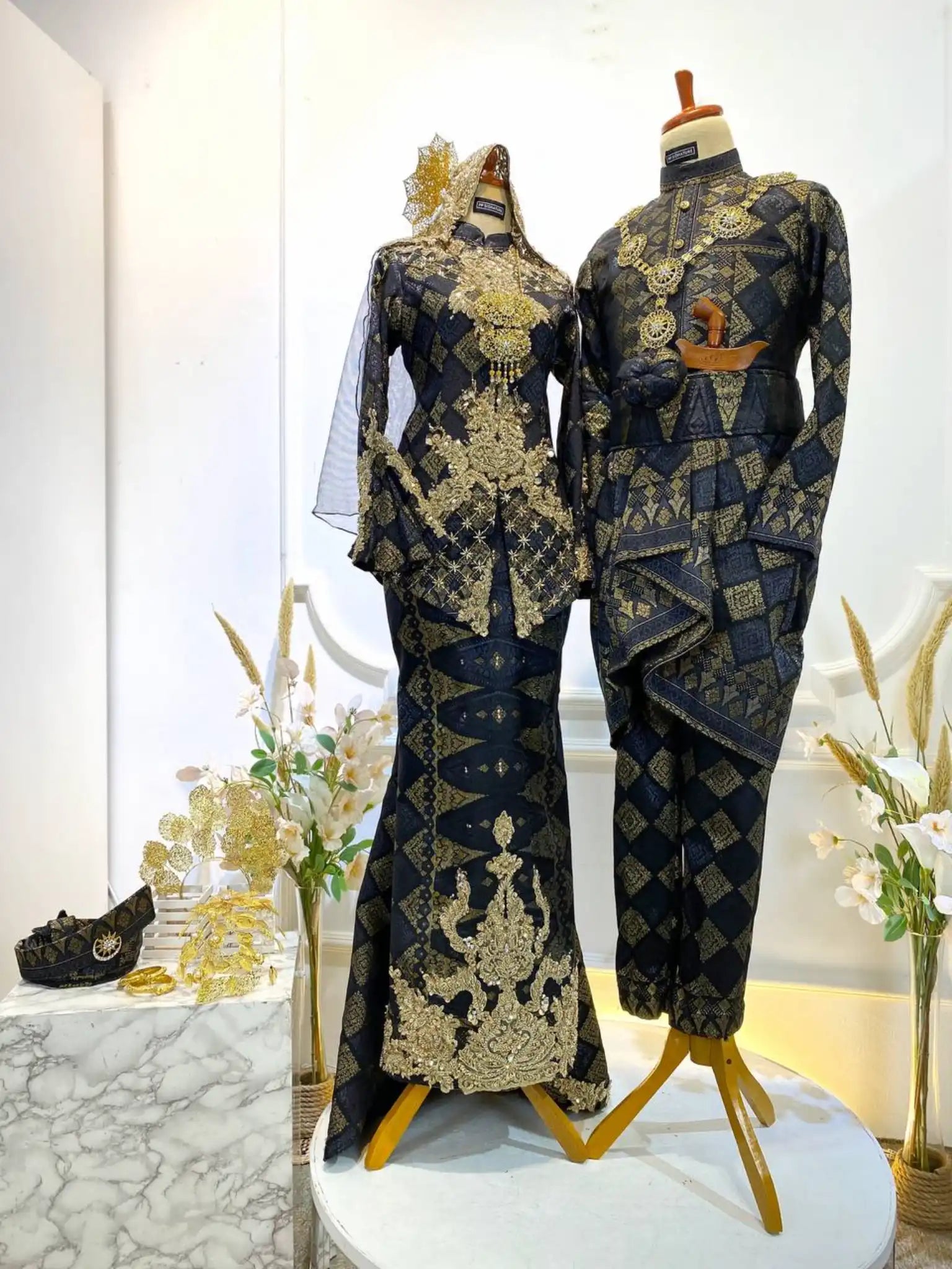 Black wedding dress-Songket wedding attire-Two-piece wedding dress-Wedding reception outfit-Traditional wedding dress-Songket fabric-Bride and groom attire-Luxury wedding dress rental-Modern wedding dress design-Malay wedding dress