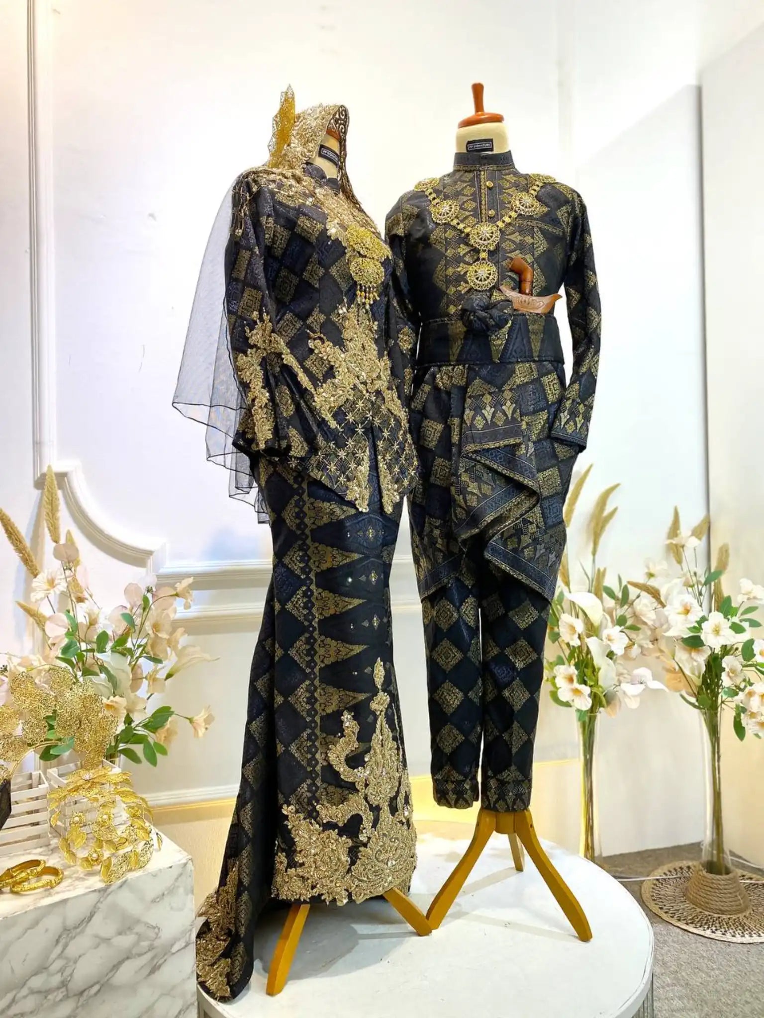 Black wedding dress-Songket wedding attire-Two-piece wedding dress-Wedding reception outfit-Traditional wedding dress-Songket fabric-Bride and groom attire-Luxury wedding dress rental-Modern wedding dress design-Malay wedding dress