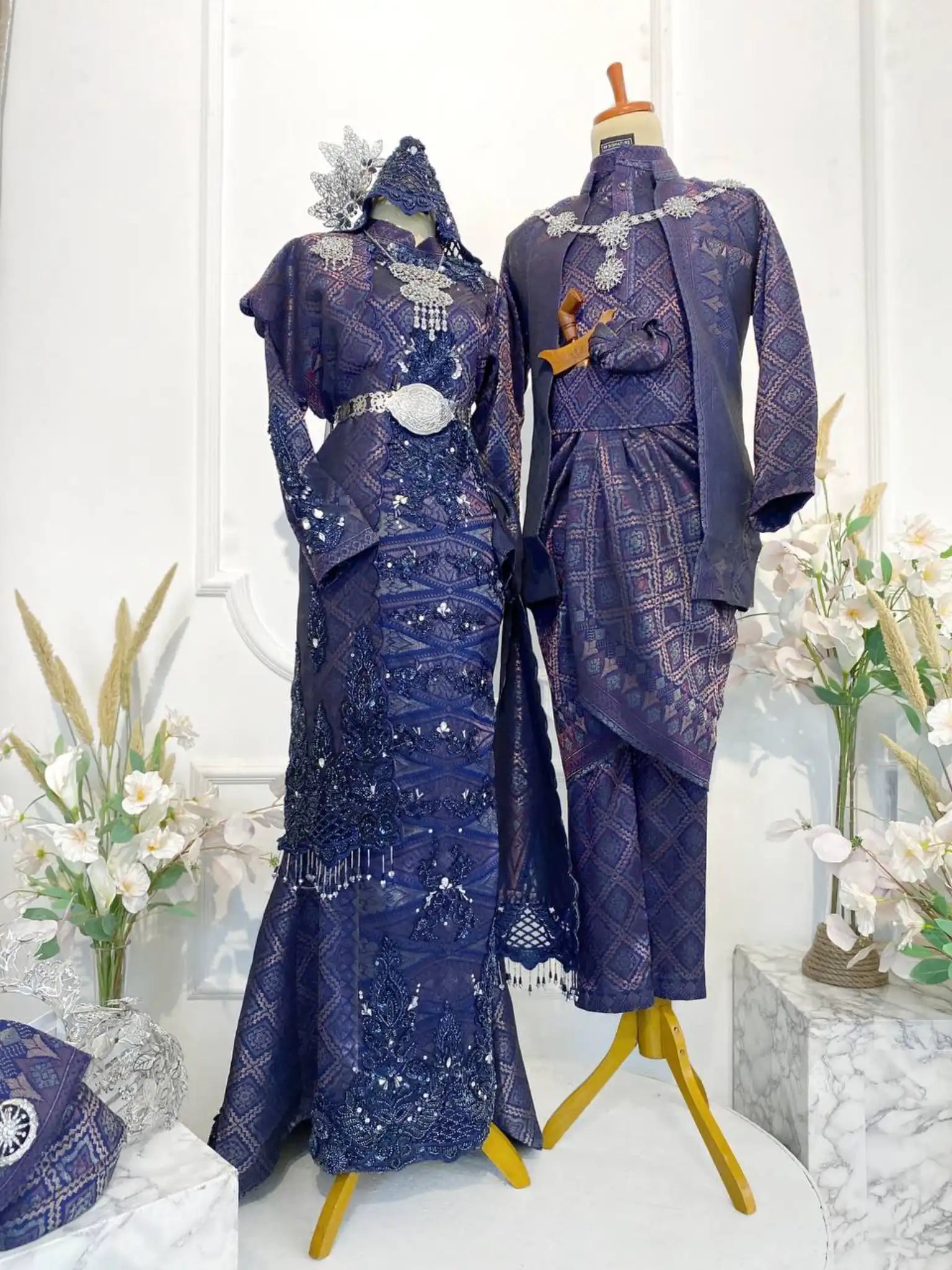 GEMAWAN Baju Pengantin Navy Blue Songket Dress with Selempang Sulam from Butik Pengantin PP Signature. This elegant wedding reception dress features Songket 3D fabric in navy blue with purple and light gold accents.