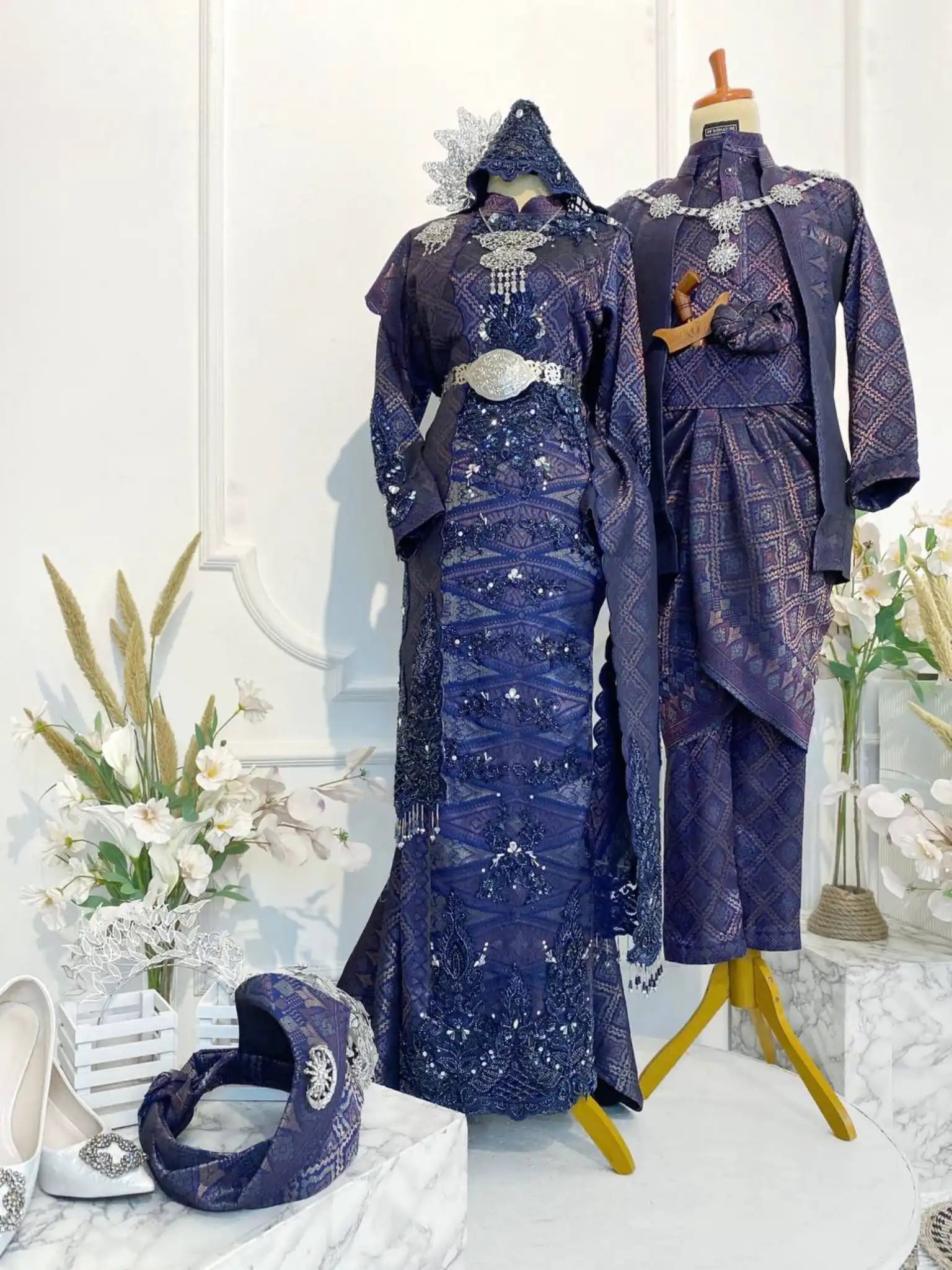 GEMAWAN Baju Pengantin Navy Blue Songket Dress with Selempang Sulam from Butik Pengantin PP Signature. This elegant wedding reception dress features Songket 3D fabric in navy blue with purple and light gold accents.