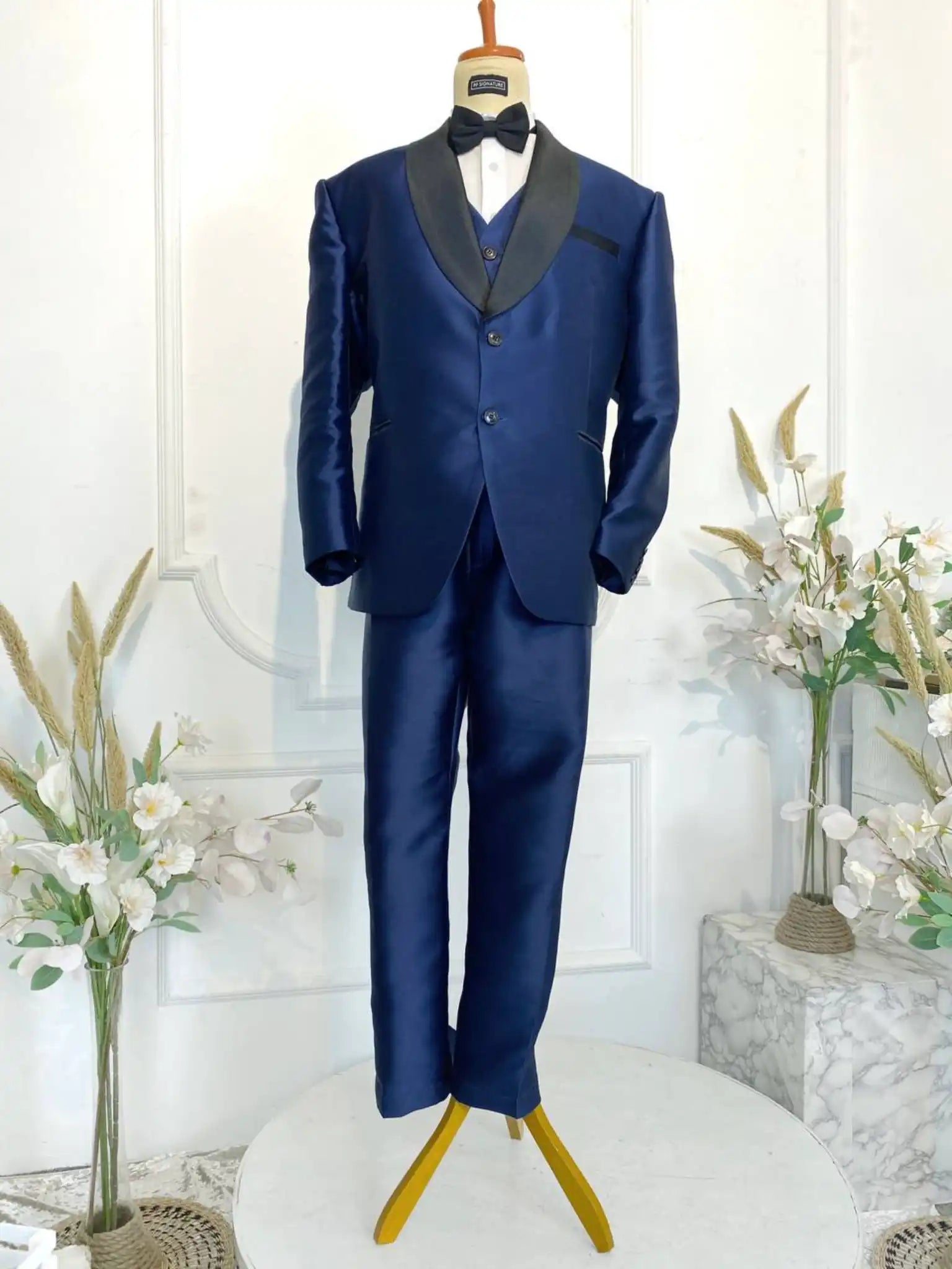 Rent the SIGNATURE NAVY 1 Navy Blue 3-Piece Signature Suit Tuxedo with Black Shawl Lapel from Butik Pengantin PP Signature for your wedding reception or formal event. Crafted from high-quality twill fabric, offering a sharp, elegant look.